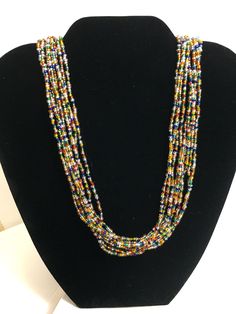 This multi strand beautiful elegant necklace features multi-color seed beads and silver magnetic clasp. It measures about 19 inches in length. All items come from a non-smoking and pet-free home. Fast and free shipping. Multicolor Small Beads Multi-strand Jewelry, Multicolor Multi-strand Beads For Jewelry Making, Multicolor Double Strand Beaded Necklace With Large Beads, Multicolor Double Strand Necklace With Large Beads, Multicolor Large Beads Multi-strand Necklace, Multicolor Large Beads Multi-strand, Multicolor Faceted Multi-strand Beads, Multicolor Large Multi-strand Beads, Multicolor Multi-strand Beaded Necklaces For Jewelry Making