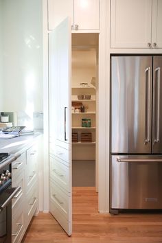 a stainless steel refrigerator freezer sitting inside of a kitchen