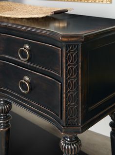 an ornate wooden desk with two drawers and a wicker basket on it's top