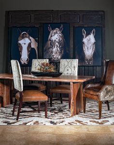 a dining room table with chairs and pictures on the wall behind it in an elegant setting