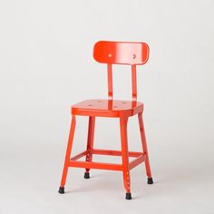 an orange chair with black wheels on the back and seat, against a white background