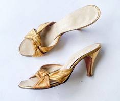 "~ 1950s beautiful gold metallic leather slides ~ Peep toe low heel style ~ Kitten heel sandals ~ Good leather soles ~ Some scuffs on side of heels only ~ Very nice Label:  I.Magnin & Co.  8 N Length- 9.75\" (24.65 cm) Width- 3\" (7.62 cm) Heel- 3.5\" (8.89 cm) More Incredible Vintage:  glennasvintageshop.etsy.com Vintage Jewelry:  glennasjewels.etsy.com Instagram @glennas_clothing Facebook  https://www.facebook.com/glennasclothing" Vintage Gold Heels For Summer, Vintage High Heel Kitten Heels For Spring, Vintage Kitten Heels For Summer, Vintage Kitten Heels For Spring, Vintage High Heel Kitten Heels For Summer, Vintage Gold Sandals With Round Toe, Retro Gold Open Toe Heels, Vintage Gold Sandals For Evening, Vintage Gold Open Toe Sandals