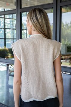 Elevate your style with the Aliya Mock Neck Sweater. Its sleek mock neck and trendy contrast trim detail add a touch of sophistication. Perfect for layering or wearing on its own, this sleeveless sweater is a versatile addition to your wardrobe. Stay cozy and chic in this oatmeal-colored sweater. General Info: 42% Acrylic, 30% Polyester, 28% Nylon Hand Wash Cold; Line Dry Mock Neck Contrast Trim Detail Sleeveless Fit Guide: Shape & Fit: Relaxed Fabric Elasticity: Stretchy Fabric Texture: Knit Model Info: Height: 5’8” | Bust: 30.5” | Waist: 23.5” | Hip: 33” | Size Shown: Small Trendy Mock Neck Top For Spring Workwear, Spring Ribbed Mock Neck Top For Layering, Casual Mock Neck Top For Spring Layering, Chic Spring Knit Mock Neck Top, Mock Neck Top With Ribbed Neckline For Layering, Mock Neck Top With Ribbed Neckline, Mock Neck Top With Ribbed High Neckline For Layering, White Mock Neck Top For Fall Layering, Spring White Mock Neck Top For Layering