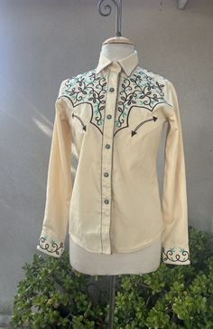 "Vintage western rodeo shirt yellow with brown green embroidery rhinestone XS Panhandle Slim. Good condition with one 1\" mark on Lower side ( last photo). Made in China of polyester rayon blend.  Measurements  Shoulders 15\" Bust 36\" Sleeves 25\" Waist 32\" Hips 36\" Length 25\"" Fitted Embroidered Top For Rodeo, Embroidered Fitted Shirt For Rodeo, Fitted Embroidered Shirt For Rodeo, Fitted Brown Shirt For Rodeo, Fitted Western Brown Shirt, Fitted Western Shirt For Western-themed Events, Fitted Brown Western Shirt, Brown Fitted Western Shirt, Western Style Brown Tops For Ranch