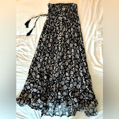 Beautiful, Feminine Flouncy Maxi Skirt. Fitted At Waist With Ties And Elastic 4” Waistband. Buttons Extend Down Front 17”, Then Midline Split. Never Been Worn. Nwt. Black Bohemian Dress With Flowy Skirt, Flowy Black Bohemian Maxi Skirt, Bohemian Black Flowy Maxi Skirt, Flowy Floral Print Dress, Black Bohemian Maxi Skirt For Summer, Casual Black Flowy Bottoms, Summer Black Lined Skirt Bottoms, Flowy Black Maxi Skirt For The Beach, Black Skirt With Elastic Waistband For Beach