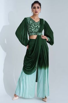 Featuring a green and sea green pant saree in tussar silk and georgette crepe base with an attached drape. It is paired with a matching padded crop top having embroidery and bishop sleeves.  FIT: Fitted at bust and waist.  COMPOSITION: Tussar silk, Georgette crepe.  CARE: Dry clean only. Plazo Saree, Skirt And Top Western Outfit, Pant Saree, Mehndi Outfits, Online Shopping Sarees, Drape Pants, Lehenga Gown, Traditional Indian Outfits, Party Wear Lehenga