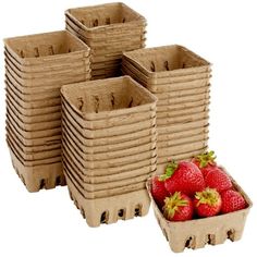 a bunch of strawberries sitting next to each other in trays on a white background