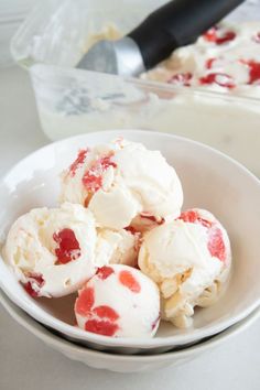 a white bowl filled with ice cream and strawberries