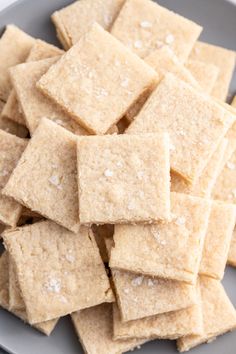 butterscotch shortbread cut into squares on a white plate with text overlay