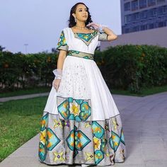 This Habesha Kemis is truly enchanting, with a gorgeous Tilf pattern intricately woven into the fabric. The diamond-shaped Tilf design adds a touch of sophistication and glamour to the dress, while the vibrant colors and intricate patterns of the Menen-like fabric give it a soft and luxurious feel. But that's not all - this Kemis also features a Shimena Tibeb, a traditional scarf draped over the head and shoulders. The Shimena adds an extra layer of elegance and grace to the dress, with its deli Eritrean Dress, Habesha Kemis, Head And Shoulders, Head & Shoulders, Diamond Shaped, Intricate Patterns, High Low Dress, Dress Length, High Waisted Skirt