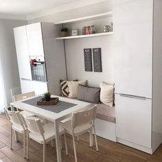 a white table and some chairs in a room