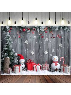 a christmas scene with presents and snowmen in front of a wooden fence decorated for the holiday season