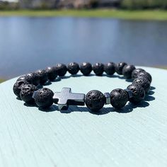 Step into a realm of serenity and spirituality with our 8mm Black Volcanic Rock Christian Beaded Bracelet. Crafted from the earth's raw energy, each volcanic rock bead embodies strength and resilience, providing a grounding foundation for your spiritual journey. At its core, a silver cross symbolizes the timeless grace and guidance found in Christian faith. As you wear this bracelet, allow its presence to anchor your intentions and connect you with the healing power of divine love. With complime Spiritual 8mm Beads Bracelet Jewelry, Spiritual 8mm Beads Bracelet, Spiritual Rosary Bracelet With Natural Stones For Meditation, Spiritual Rosary Bracelet With 108 Beads As Gift, Spiritual Rosary Bracelet As Gift, Spiritual 8mm Beads Wristband Bracelet, Spiritual 8mm Beads Wristband, Spiritual 8mm Beads Wristband For Healing, Spiritual 8mm Beaded Wristband Bracelet