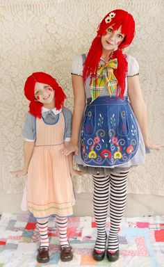 two dolls are standing next to each other