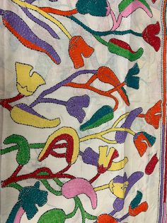 an embroidered cloth with colorful designs on it