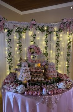 a table topped with lots of cupcakes and cakes