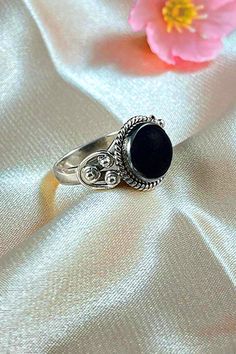 Sanskrit for divine, Divya symbolizes the life energy within us which connects to the divine energy of the universe. Our Divya ring is handcrafted in fine sterling silver, with signature textured detailing and an authentic large solitaire gemstone as a centerpiece, adding sophistication to your everyday look. Authentic Sivalya Black Onyx Hallmarked Metal: 925 Sterling Silver Gemstone Size: 10mm x 10mm Cut: Round Shaped Smooth Cabochon Black Onyx: Endurance, Perseverance, Grounding Symbolic Black Gemstone Jewelry, Traditional Black Jewelry With Polished Finish, Traditional Black Sterling Silver Rings, Spiritual Onyx Ring Jewelry, Traditional Black Ring Jewelry, Traditional Black Rings For Anniversary, Spiritual Black Onyx Rings, Black Spiritual Round Rings, Spiritual Oval Onyx Rings