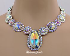 This necklace was created with Swarovski crystals in crystal aurora borealis. The necklace has a large pear and oval shaped crystals creating this dramatic effect! This will fill in the neckline of your dress. Be sure to look at the matching bracelet and earrings. The stones are not secured with any metal fittings so this will not snag your costume or your partners. This design will match any dress that you own because it has flesh tone background the only thing visible are the crystals. It will Oval Crystal Necklaces For Parties, Elegant Iridescent Crystal Necklace, Elegant Iridescent Crystal Necklaces, Clear Crystal Necklace, Shaped Crystals, Chunky Jewelry, Swarovski Necklace, Royal Design, Jewelry Techniques