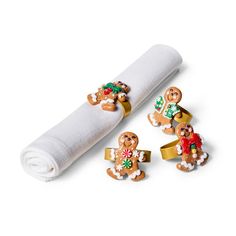 napkin rings with gingerbreads and christmas decorations on them next to a napkin roll