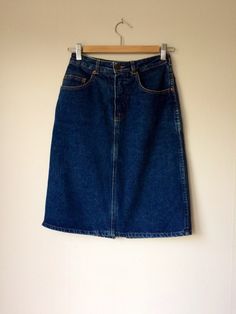 A fantastic piece that is sure to become a favorite and a staple in your wardrobe for years and years.  Ladies vintage denim pencil skirt with a slight A-line cut and slit in the back Classic dark wash that will only get better with age Gold stitching with classic back pockets  Great with boots and a chunky sweater in the winter or some strapping leather sandals and tee shirt or tank in the summer. And don't forget to accent that tiny waist with a great belt--there's a few to choose from at The Silky Weasel.  Buffalo Size extra small-small Measures: 27" around the waist  22" from top of waistband to bottom hem 1.5" belt loops Denim Pencil Skirt, Denim Blazer, Vintage Clothes, Chunky Sweater, Get Better, Vintage Skirt, Vintage Denim, Leather Sandals, Denim Skirt