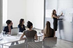 a woman giving a presentation to her colleagues