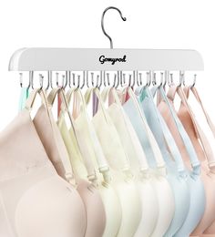 an assortment of bras hanging on a white hanger with the word glymond written above them