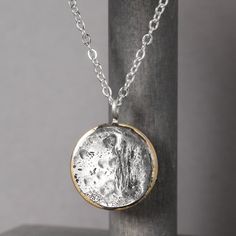 In 2017, the solar eclipse's path of totality found its way to Casper, Wyoming and sparked pure magic. Our Solar Eclipse Necklace is meant to do just that. Inspired by the celestial spectacle, we hope this handmade piece reminds you to look up and see the world through new eyes from time to time. Handcrafted with love in the heart of Wyoming. Necklace Details Pewter & Brass Charm on a dainty bail Sterling silver chain - choose your length Includes jewelry care card & polishing pad Free standard Artisan Silver Necklace With Moon Phase, Artisan Silver Necklace With Moon Phase Detail, Spiritual Moon Phase Round Pendant Necklace, Artisan Silver Jewelry With Moon Phase, Artisan Moon Charm Necklaces, Unique Silver Moon Phase Necklace, Unique Silver Necklace With Moon Phase Detail, One-of-a-kind Celestial Jewelry Gift, Spiritual Orb-shaped Jewelry Gift