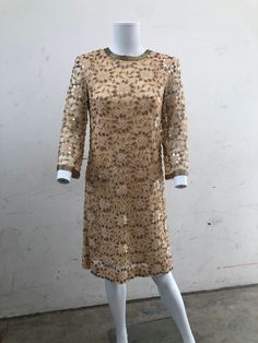 This rare 1950's original beaded dress is in very good condition. It has interesting floral bead design, 3/4 sleeve and zip detail at the back. Considering how old it is the beads are in very good condition and it looks barely worn. Vintage Long Sleeve Evening Mini Dress, Vintage Long Sleeve Mini Dress For Evening, Gold Long Sleeve Mini Dress For Wedding, Gold Sequin Formal Dress For Spring, Gold Embellished Long Sleeve Sequin Dress, Gold Embellished Mini Dress For Formal Events, Formal Gold Embellished Mini Dress, Gold Embellished Mini Dress For Formal Occasions, Vintage Embellished Long Sleeve Dresses