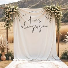 an outdoor wedding ceremony setup with flowers and greenery