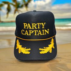 PARTY CAPTIAN embroidered on a black with gold leaf Otto Foam High-Profile Trucker Hat. *Message us if you are looking for a different color hat or thread or with any other questions. *Saying can be customized. Please message us before ordering.  Hat Description:  The Traditional Look 5-panel cap Seamless Foam Front Panel with Lining Matching Color Braid Visor Matching Fabric Undervisor, Adjustable Snapback SHAPE: High-Profile FABRIC:  100% Polyester Front,  Mesh Back VISOR: Pre-curved FIT & SIZ Novelty Mini Cap Hats For Party, Novelty Costume Hat With Short Brim For Parties, Halloween Party Costume Cap, Halloween Party Mini Cap Hats, Novelty Party Hats With Short Brim, Gold Baseball Cap For Summer, Carnival Party Costume Cap, Novelty Trucker Hat For Party, Black Trucker Hat For Party With Curved Brim