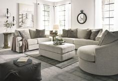 a living room filled with furniture and a clock on the wall