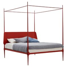 a bed that has a red frame and pillows on it, with a white background