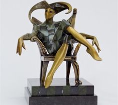 a statue of a woman sitting in a chair