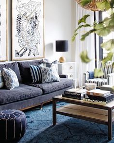 an image of a living room with blue and white decor on the walls, couches and coffee table