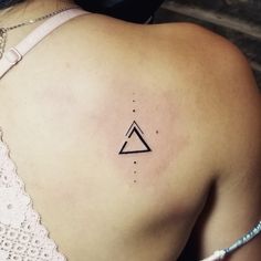 a woman with a triangle tattoo on her back