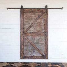 an old wooden door is hanging on the wall