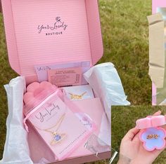 a person holding a pink box with jewelry in it and a flower brooch on the inside