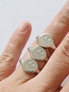 "\"Smile , it's contagious ! Let's pass it on :) \" *Good vibes Only ! These smiley signet rings are hand carved in wax and cast in silver with the lost wax technique . A perfect and timeless reminder for you or your loved ones . *Available in Sterling Silver ,Gold Vermeil ,Rose Gold Vermeil and in SOLID YELLOW GOLD 9K . * SHINY or MATTE finish . *Need it fast ? You can upgrade shipping with FedEx here : https://www.etsy.com/listing/966774899/fedex-tnt-express-shipping-delivery?ref=shop_home_act Smiley Face Ring As Gift, Novelty Smiley Face Jewelry As Gift, Novelty Smiley Face Jewelry For Gifting, Novelty Smiley Face Jewelry For Gifts, Novelty Smiley Face Jewelry Gift, Lost Wax Casting Rings, Lost Wax Casting Jewelry, Hand Carved Ring, Art Clay Silver