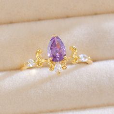 This page is for the ring with the purple pear-cut gemstone and the vintage-style vine setting. 💎 Materials: 18k gold plated brass Cubic zirconia stones 📐 Size: adjustable open design for size 5.5+ 📌 Please Note: When adjusting the ring, please squeeze or expand the ring body slowly and gently. Tangled Themed Engagement Rings, Elegant Adjustable Amethyst Gold Ring, Elegant Adjustable Gold Amethyst Ring, Elegant Gold Teardrop Crystal Ring, Gold Amethyst Ring With Cubic Zirconia For Promise, Rapunzel Ring, Alice In Wonderland Dress, Purple Ring, Catholic Churches