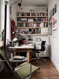 a home office with bookshelves, desk and chair