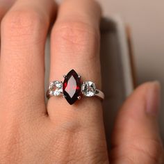 Red Marquise Ruby Ring With Prong Setting, Classic Marquise Red Diamond Ring, Classic Red Marquise Diamond Ring, Classic Ruby Jewelry With Marquise Cut, Classic Marquise Cut Ruby Jewelry, Red Marquise Rings With Prong Setting, Marquise Ruby Ring For Anniversary, Marquise Ruby Birthstone Ring, Marquise Ruby Ring With Center Stone