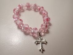 Handmade, stretch bracelet. Roll on for ease of wear. Would make a good addition to your bracelet collection or make a nice gift for someone. The size is 7 inches. If you have any questions, please leave me a message. Thank you. Adjustable Pink Cross-shaped Jewelry, Pink Cross Bracelet For Gift, Pink Cross Bracelet For Gifts, Pink Cross Rosary Bracelet Gift, Pink Cross-shaped Rosary Bracelet Gift, Adjustable Pink Cross Bracelet, Pink Adjustable Cross-shaped Bracelets, Christian Bracelets, Pink Cross