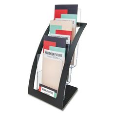 a stack of folders sitting on top of a black stand