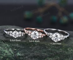 three different types of engagement rings sitting on top of a rock