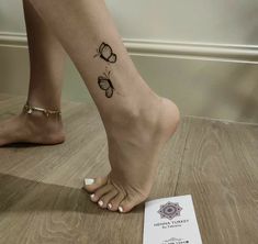 a woman's foot with butterfly tattoos on it