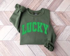 Lucky Sweatshirt, Retro Lucky Shirt, Cute Lucky Sweatshirt, Irish Shirts, St. Patrick's Day Shirts, Lucky Sweater, Green Sweatshirts DETAILS Bella+Canvas Greenwich Unisex T-shirt 4.2 oz.(US) 7 oz.(CA), 100% airlume combed and ringspun cotton, 32 singles Retail fit Unisex sizing Coverstitched collar and sleeves Shoulder-to-shoulder taping Side seams Tear-away label Fabric Profile : Ash is 99/1 airlume combed and ringspun cotton/polyester GILDAN CREWNECK SWEATER Features 8 oz., 50% cotton, 50% polyester 1x1 ribbed collar, cuffs and waistband with spandex Double-needle stitching throughout Pill-resistant air jet yarn Set-in sleeves WASHING INSTRUCTIONS Please wash us inside out in cool water + for best results dry flat & do not iron directly on image. Following these washing instructions is v Irish Women, Shamrock Shirt, St. Patricks Day, Lucky Shirt, St Patrick's Day Gifts, Green Sweatshirt, St Patrick Day Shirts, St Pattys, St Pattys Day