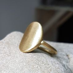 A delicate signet ring, handcrafted in 18k brushed gold. A ring that speaks of strength, with feminine flowing lines. This ring is beautiful just as is, or it can be personalized with an engraving or a gemstone, to tell a special story and hopefully to become a family heirloom one day . The price includes an engraving of a name, and a 1 point diamond / precious gemstone of your choice, which will be set in the ring. This ring would make a beautiful, meaningful gift! It will be custom made, so pl Modern Yellow Gold Recycled Signet Ring, Elegant Oval Hand Forged Signet Ring, Elegant Hand Forged Oval Signet Ring, Hand Forged Oval Signet Ring, Hand Forged Elegant Oval Signet Ring, Elegant Hand Forged Open Signet Ring, Gold Oval Ring With Smooth Finish, Elegant Hammered Yellow Gold Dome Ring, Elegant Yellow Gold Hammered Dome Ring