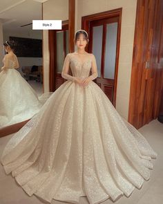 a woman in a wedding dress standing next to a mirror