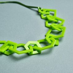 Lime green modern geometric chain link acrylic necklace for the jewellery lover who likes simple design and colourful jewellery.  My necklaces are light and easy to wear and will give your favourite outfit an instant pop of colour. A perfect statement necklace for day or evening wear. Designed using 15 laser cut perpsex shapes linked together the necklace is 26 inches long with a drop of 13 inches.  Finished with silky green cord and a silver plated magnetic clasp. This clasp is very easy to use Trendy Green Necklace For Party, Trendy Geometric Green Jewelry, Trendy Green Geometric Jewelry, Green Minimalist Chain Necklace With Adjustable Chain, Green Adjustable Chain Necklace For Party, Modern Green Geometric Jewelry, Green Chunky Chain Necklace As Gift, Trendy Green Chain Necklace With Adjustable Chain, Trendy Green Adjustable Chain Necklace