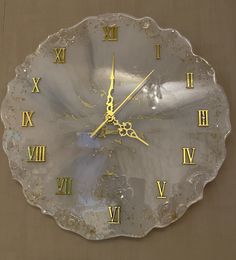 a clock with roman numerals on the face and numbers painted on the sides